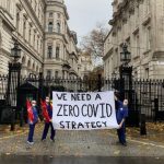 Health workers outside Downing Street holding a 'We need a Zero Covid Strategy' banner