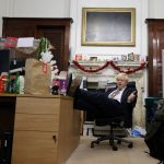 BorisJohnson sits in an office somewhere surrounded by various items of mess